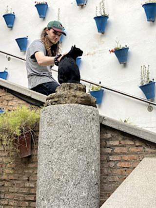 Jess Cavalari petting a cat in Seville, Spain