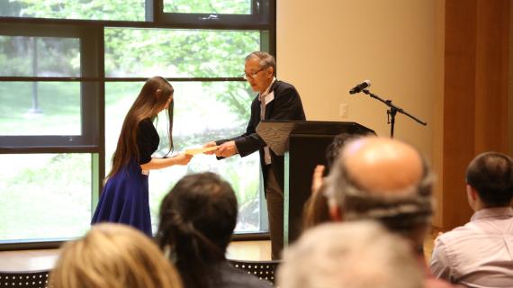 Anand Yang presenting Hannah with her award.