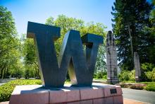 W at the north entrance to campus