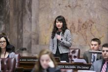 UW History Alum Cynthia Meng speaks on the senate floor during her internship with the Washington State Legislature.