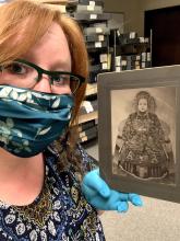 Amanda Robb, working at Hoover Institutions, with a potrait of Empress Dowager Cixi