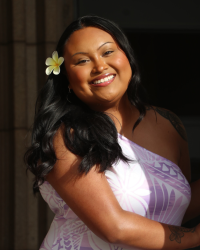 Aliyah Adelita Siva with purple Samoan tribal dress and flower in hair.