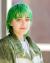 Professional headshot of Ari Forsyth, a white gender non-conforming person in their mid-20s with short green hair