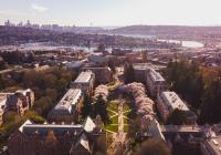 An ariel view of the University of Washington Quad during cherry blossom time looking out towards the downtown Seattle
