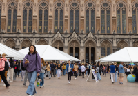 Students walk through Red Square near white tents.