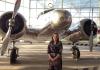 Anne Melton standing in front of propeller airplane