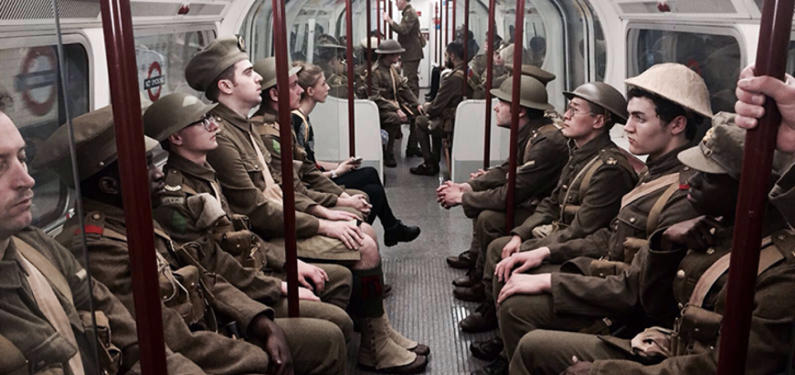 actors and artists performing world war soldiers riding London subway